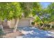 Inviting two-story home featuring mature landscaping, a two car garage and tiled roof at 10716 Aire Dr, Las Vegas, NV 89144