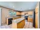 Well-lit kitchen with granite countertops, stainless steel appliances and tile flooring at 10716 Aire Dr, Las Vegas, NV 89144