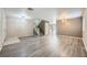 Spacious living room featuring vinyl flooring, stairs to second floor, and dining area at 10716 Aire Dr, Las Vegas, NV 89144