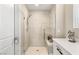 This bathroom has a modern walk-in shower with seating and grab bars, complemented by a stylish vanity at 10890 Red Yucca Dr, Las Vegas, NV 89138