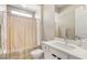 Bathroom featuring a shower with a shower curtain, toilet, sink and vanity at 10890 Red Yucca Dr, Las Vegas, NV 89138