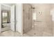 This modern bathroom showcases a tiled walk-in shower with glass enclosure and bench seating at 10890 Red Yucca Dr, Las Vegas, NV 89138