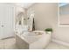 Bright bathroom features a soaking tub with tile surround and a decorative towel ladder at 10890 Red Yucca Dr, Las Vegas, NV 89138