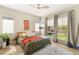 Comfortable bedroom with large windows providing lots of natural light and a ceiling fan at 10890 Red Yucca Dr, Las Vegas, NV 89138