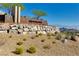 Community sign with lush desert landscaping and mountain views at 10890 Red Yucca Dr, Las Vegas, NV 89138