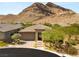 Beautiful single-story home with desert landscaping and brick driveway in front of a mountain at 10890 Red Yucca Dr, Las Vegas, NV 89138