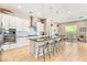 Modern kitchen with white cabinets, a large island with bar seating, and stainless steel appliances at 10890 Red Yucca Dr, Las Vegas, NV 89138