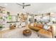 Open-concept living area featuring stylish decor, a leather sofa, and a modern kitchen with stainless steel appliances at 10890 Red Yucca Dr, Las Vegas, NV 89138