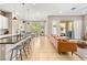 Bright, open living area featuring tile flooring, a leather sofa, and access to an outdoor patio at 10890 Red Yucca Dr, Las Vegas, NV 89138
