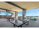 Outdoor recreation area with ping pong and billiard tables under a covered patio at 10890 Red Yucca Dr, Las Vegas, NV 89138