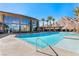 Resort-style pool with a modern clubhouse, palm trees, and mountain views at 10890 Red Yucca Dr, Las Vegas, NV 89138