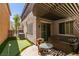 Back patio area with hot tub, stone pavers, and lush turf, perfect for outdoor relaxation and entertainment at 11063 Mount George St, Las Vegas, NV 89179