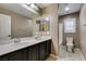 Primary bathroom with double sinks, dark cabinets and tile floors at 11063 Mount George St, Las Vegas, NV 89179