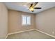This carpeted bedroom features a ceiling fan and bright window with plantation shutters at 11063 Mount George St, Las Vegas, NV 89179