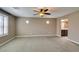 Spacious bedroom featuring plush carpeting, a ceiling fan, and bright windows with elegant shutters at 11063 Mount George St, Las Vegas, NV 89179