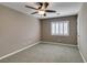 This carpeted bedroom features a ceiling fan and bright window with plantation shutters at 11063 Mount George St, Las Vegas, NV 89179
