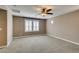 Expansive bedroom with neutral walls, soft carpet, and shuttered windows for optimal light control at 11063 Mount George St, Las Vegas, NV 89179