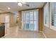 Dining area with tile flooring and sliding doors with white shutters for ample natural light at 11063 Mount George St, Las Vegas, NV 89179