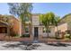 Inviting two-story home with a stone facade and a well-maintained front yard, showcasing curb appeal at 11063 Mount George St, Las Vegas, NV 89179