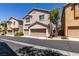 Beautiful home with a two-car garage, complemented by lush greenery and curb appeal at 11063 Mount George St, Las Vegas, NV 89179