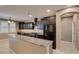 Kitchen with dark cabinets, granite countertops, stainless steel appliances, and tile floors at 11063 Mount George St, Las Vegas, NV 89179