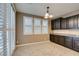 Inviting dining area with modern lighting, plantation shutters, dark cabinets and granite countertops at 11063 Mount George St, Las Vegas, NV 89179