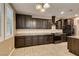 Well-equipped kitchen featuring sleek, dark cabinetry, granite countertops and a range oven at 11063 Mount George St, Las Vegas, NV 89179