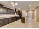 Large kitchen with dark cabinets, granite countertops, stainless steel appliances, and tile floors at 11063 Mount George St, Las Vegas, NV 89179