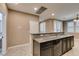 Kitchen island with granite countertops, dark cabinets, and stainless steel appliances at 11063 Mount George St, Las Vegas, NV 89179
