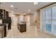 Bright kitchen boasts dark cabinets, stainless steel appliances, and an island with granite countertops at 11063 Mount George St, Las Vegas, NV 89179