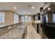Spacious kitchen with stainless steel appliances, granite countertops, dark cabinets, and tile floors at 11063 Mount George St, Las Vegas, NV 89179