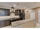 Stylish kitchen features granite countertops, stainless steel appliances, and dark cabinetry at 11063 Mount George St, Las Vegas, NV 89179