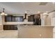 Inviting kitchen with dark cabinets, granite countertops, and stainless steel appliances at 11063 Mount George St, Las Vegas, NV 89179