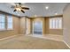 Large living space with tile entry leading to carpeted area, recessed lights and large windows at 11063 Mount George St, Las Vegas, NV 89179