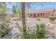 Well-maintained backyard featuring decorative rock, mature landscaping and low-water plants at 1174 Monogram Way, Las Vegas, NV 89123