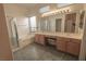 Bathroom includes dual sinks, a soaking tub, and a glass-enclosed shower at 1174 Monogram Way, Las Vegas, NV 89123