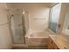 Bright bathroom with a separate shower, bathtub, and window at 1174 Monogram Way, Las Vegas, NV 89123