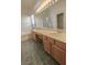 Bathroom showcasing dual sinks, tile floors, and a separate tub and shower at 1174 Monogram Way, Las Vegas, NV 89123