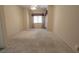 Large, carpeted bedroom with natural light, a ceiling fan, and neutral walls at 1174 Monogram Way, Las Vegas, NV 89123