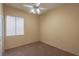 Cozy bedroom featuring carpet flooring, a ceiling fan, and a window at 1174 Monogram Way, Las Vegas, NV 89123