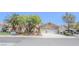 Charming single-story home featuring a three-car garage and mature landscaping at 1174 Monogram Way, Las Vegas, NV 89123