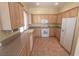 Well-lit kitchen features wooden cabinets, granite countertops, and modern appliances at 1174 Monogram Way, Las Vegas, NV 89123