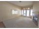 Cozy living area boasts plush carpet, fireplace, and sliding doors to the outside at 1174 Monogram Way, Las Vegas, NV 89123