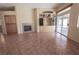 Open living area featuring a cozy fireplace, custom built-ins, and glass patio doors at 1174 Monogram Way, Las Vegas, NV 89123