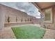 Low-maintenance backyard featuring green turf and rock landscaping at 11904 Glide Reflection Ave, Las Vegas, NV 89138