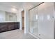 Modern bathroom features a glass shower and vanity with dark brown cabinets at 11904 Glide Reflection Ave, Las Vegas, NV 89138