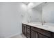 Bathroom featuring double sinks, a large mirror, and modern cabinetry at 11904 Glide Reflection Ave, Las Vegas, NV 89138