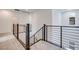 Upstairs hallway featuring modern stainless steel railing and carpet flooring at 11904 Glide Reflection Ave, Las Vegas, NV 89138