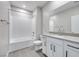 Modern bathroom featuring a white tub with tile surround and a vanity with sleek fixtures at 11922 Glide Reflection Ave, Las Vegas, NV 89138