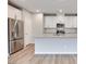 Bright, modern kitchen features stainless appliances, white cabinets, and island at 11922 Glide Reflection Ave, Las Vegas, NV 89138